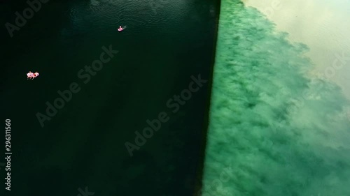 Aerial drone flight over border of confluence of Rhone and Arve with swimmers, Geneva, Switzerland, 4k photo