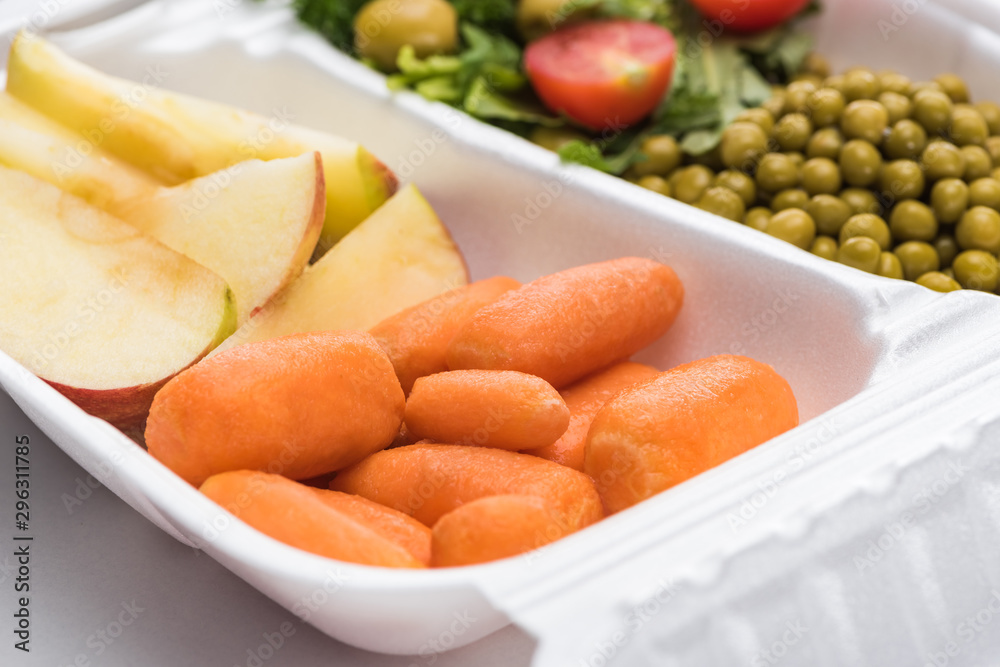selective focus of eco package with vegetables, apples and salad on white background selective focus of eco package with vegetables, apples and salad on white background