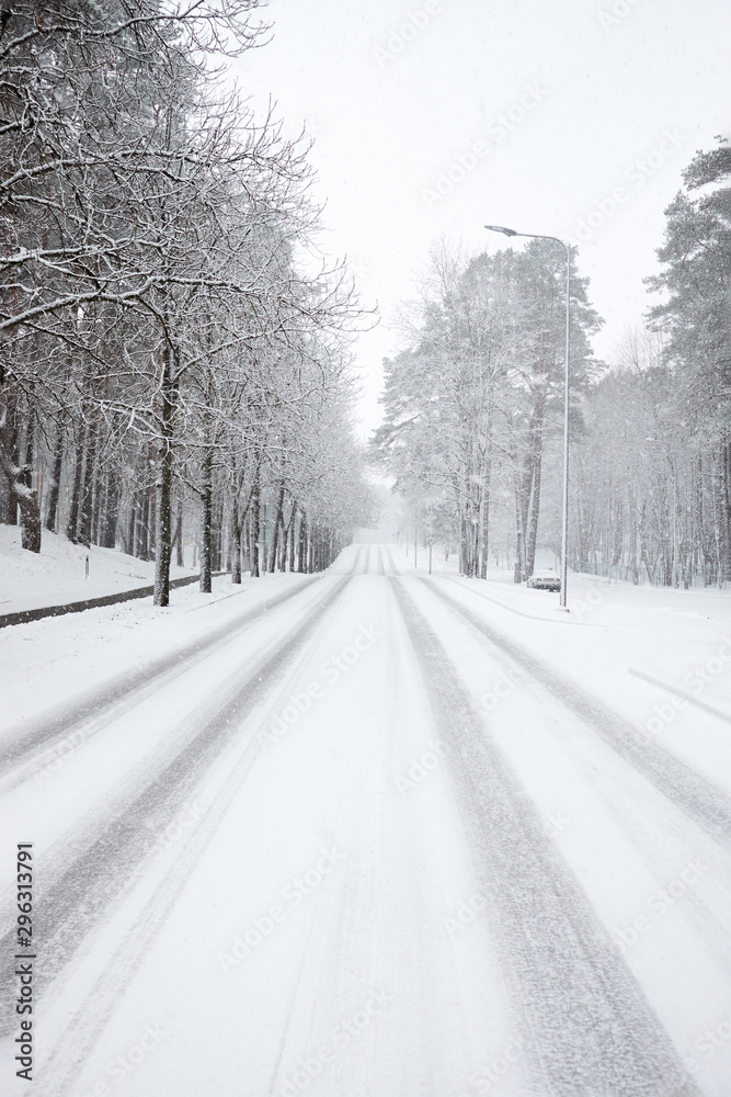 Snow covered road during snowfall Snow covered road during snowfall