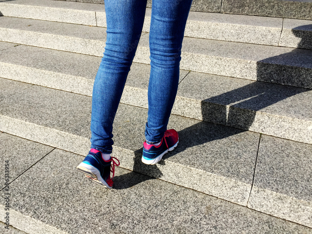 Young sport woman running up on stone stairs with sun spot background. Healthy lifestyle, workout and diet concept. Young sport woman running up on stone stairs with sun spot background. Healthy lifestyle, workout and diet concept.
