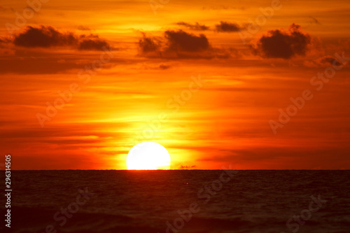 the setting Golden sun turned the sky red over the ocean © eevlada