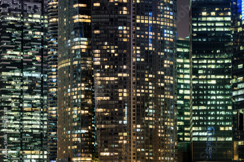 Glowing windows of skyscrapers at evening. Night cityscape