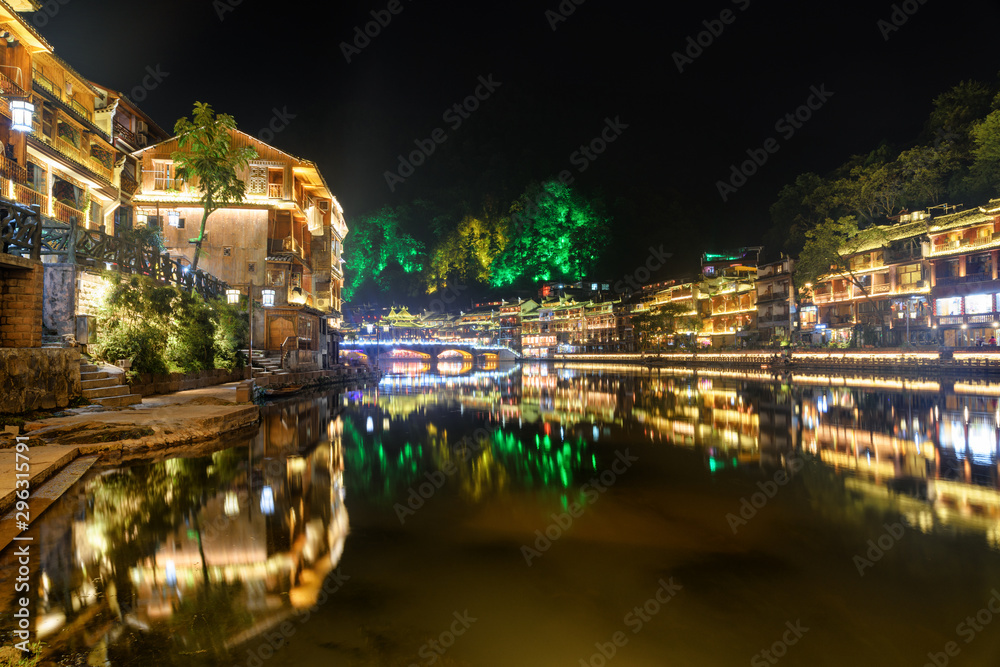 Amazing night view of Phoenix Ancient Town reflected in water