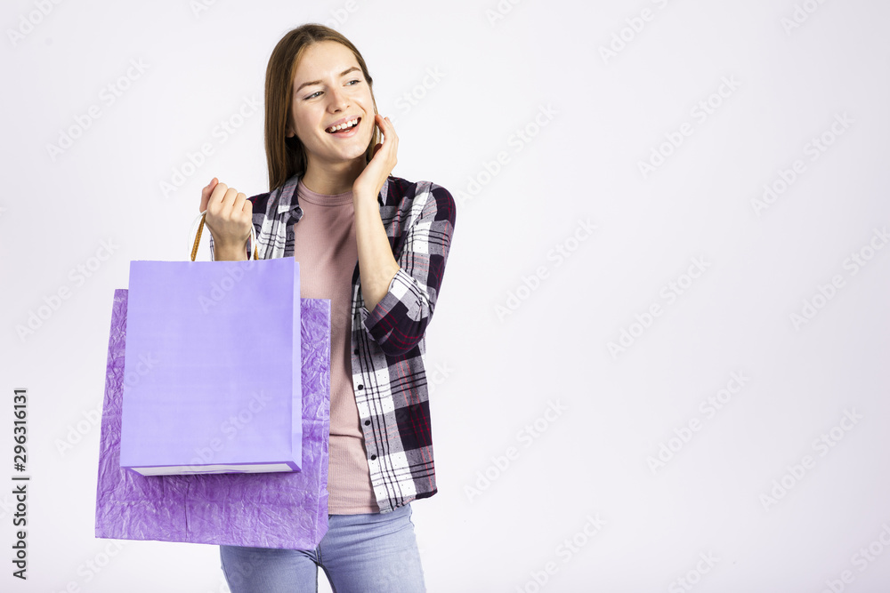 Mid shot woman holding bags and looking away Mid shot woman holding bags and looking away