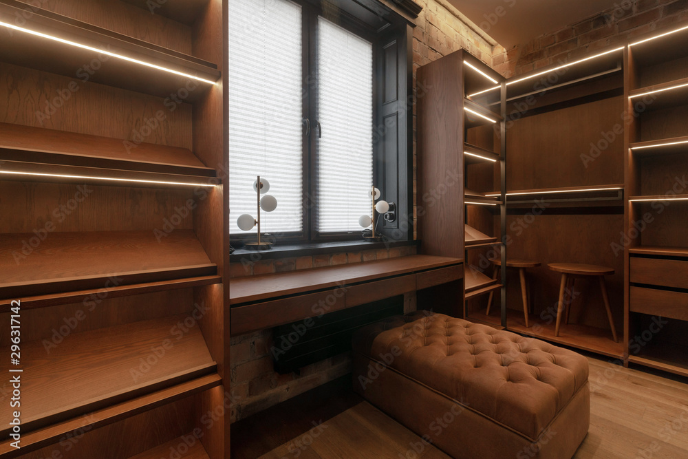 Dressing room with empty shelves ottoman chairs with window Dressing room with empty shelves ottoman chairs with window