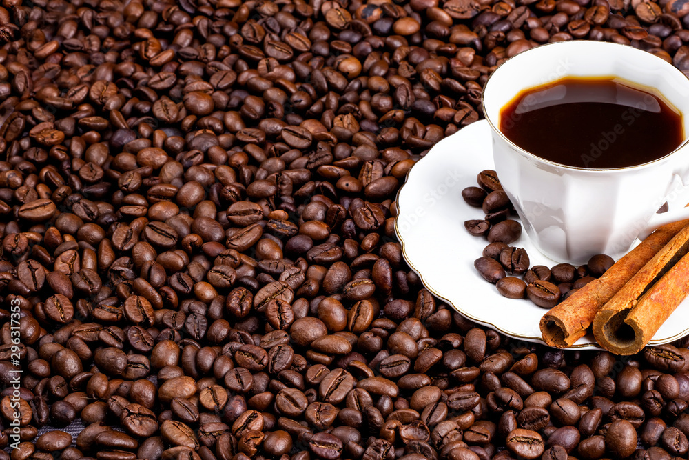 Coffee beans and a cup of coffee with cinnamon. Horizontal view Coffee beans and a cup of coffee with cinnamon. Horizontal view