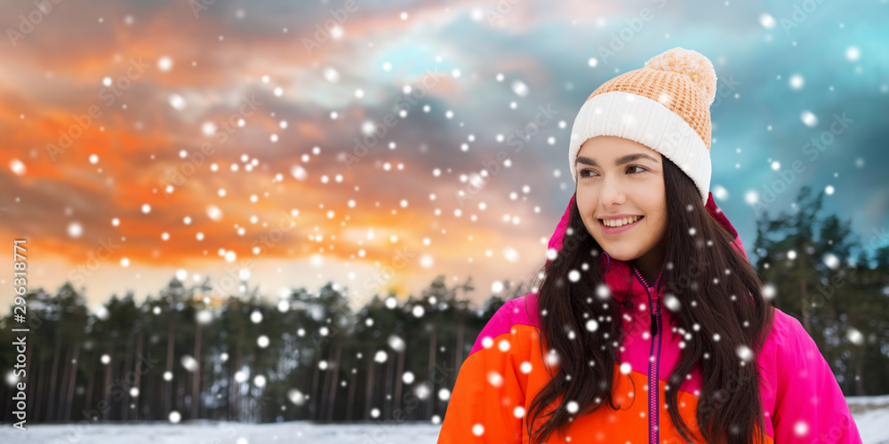 leisure, clothing and people concept - happy young woman over winter forest background leisure, clothing and people concept - happy young woman over winter forest background