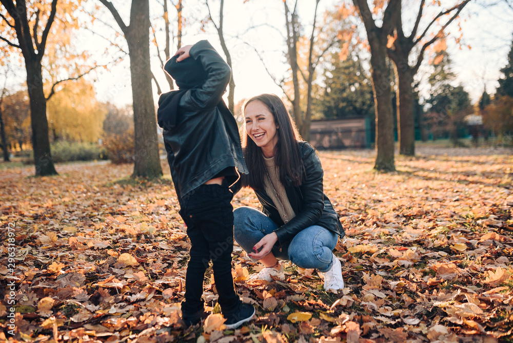 Happy mother and son in autumn city park Happy mother and son in autumn city park