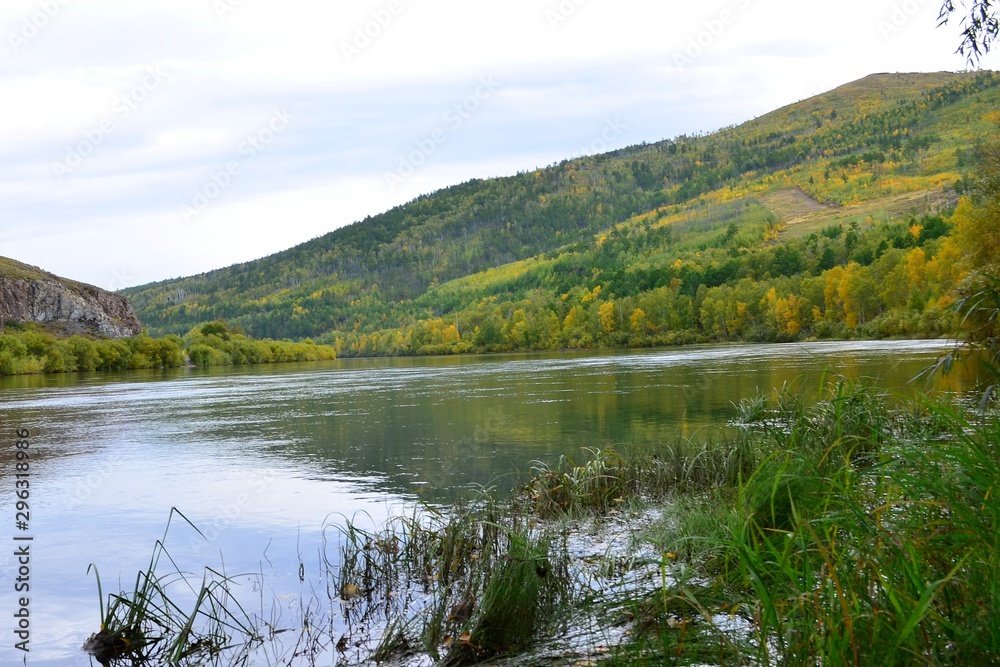 Beautiful landscape of the beginning of autumn on the river bank.