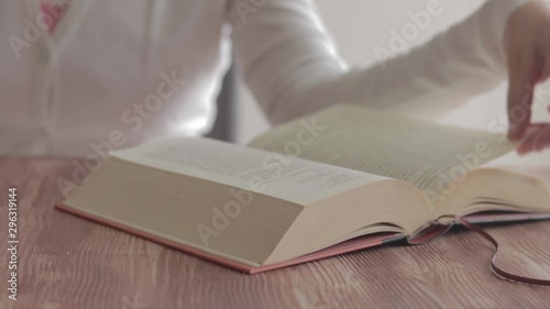 Woman reading book and eating fruit. Slide shot.