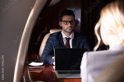selective focus on business coworkers in plane © LIGHTFIELD STUDIOS
