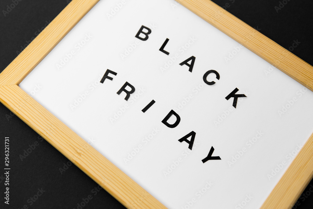 shopping, sale and outlet concept - white magnetic board with black friday words shopping, sale and outlet concept - white magnetic board with black friday words