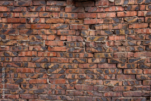 Brick wall of red bricks.