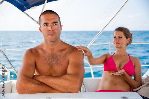 Woman talking to offended husband on yacht