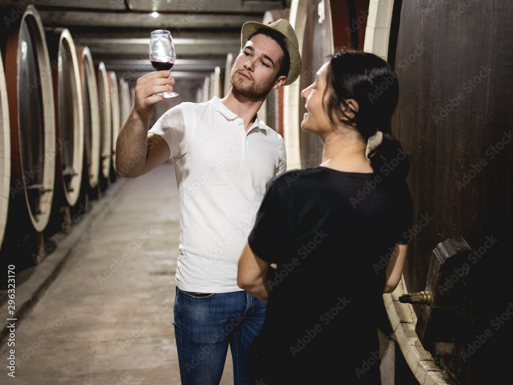 Obraz premium A mother and her son try wine at their winery
