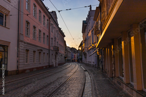 Street of the city center of freiburg, germany, in sunset