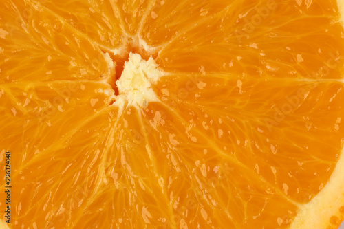 Ripe juicy orange half cut closeup on white background