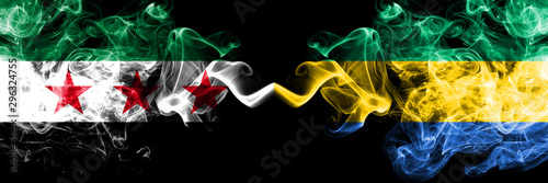 Syrian Arab Republic vs Gabon, Gabonese smoke flags placed side by side. Thick colored silky smoke flags of Syria opposition and Gabon, Gabonese photo