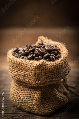 Coffee beans in sack on wood table