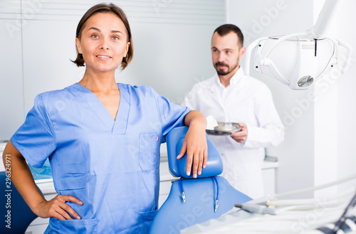 Fototapeta Naklejka Na Ścianę i Meble -  doctor with assistant are posing on workplace in hospital