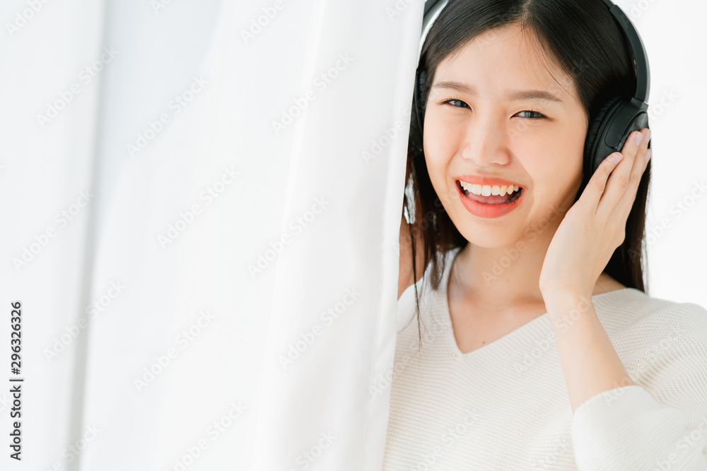 happiness beauty asian woman enjoy song music with headphone medium shoy on in living room white curtain background happiness beauty asian woman enjoy song music with headphone medium shoy on in living room white curtain background