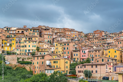 Colorful Buildings in Siena Italy with dark cloudy sky