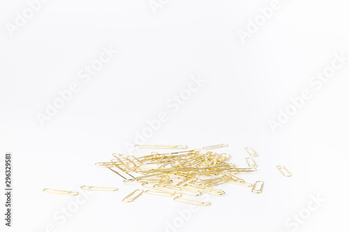 Gold paperclips isolated on a white background