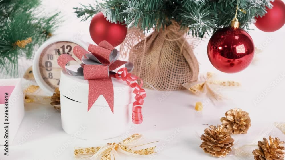 White rat crawls in the New Year decorations, Christmas trees toys, balls. Symbol of the new 2020 and 2032.