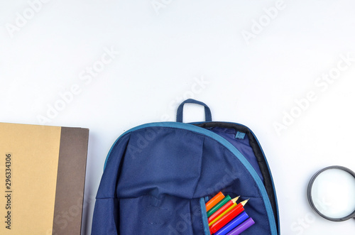 View of flat lay with school backpack and stationery with space for text on white background. Selective focus.