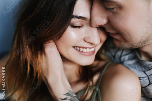 Kissing couple portrait. Young couple deeply in love sharing a romantic kiss, closeup profile view of their faces