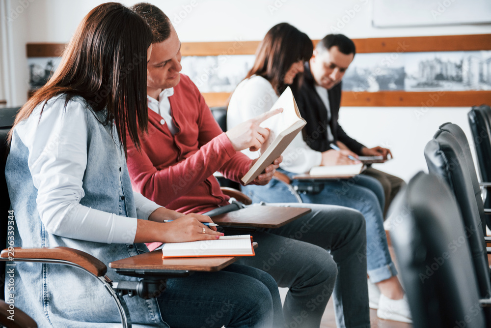 Active conversation. Group of people at business conference in modern classroom at daytime Active conversation. Group of people at business conference in modern classroom at daytime