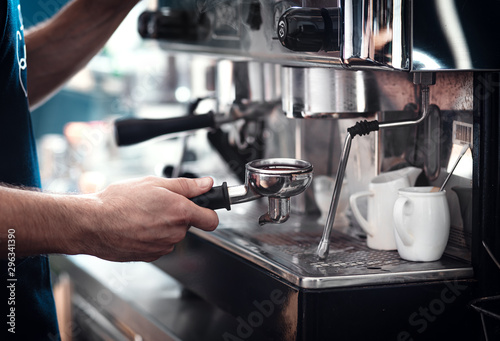 Close up of barista hands preparing cappuccino.