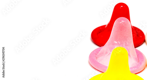 Colorful latex condom on white background
