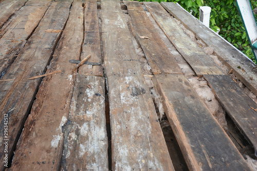  Old house roof with bad wet wooden beams and wet rock wool insulation material. Roofing construction