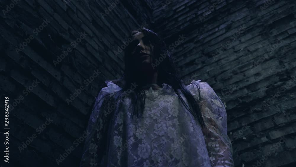 Creepy woman looking up, lost in strange abandoned building, scary nightmare Creepy woman looking up, lost in strange abandoned building, scary nightmare