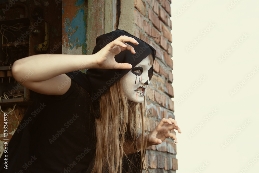 Naklejka premium Zombie crawls out from an abandoned house. Toned. Halloween and day of the dead concept