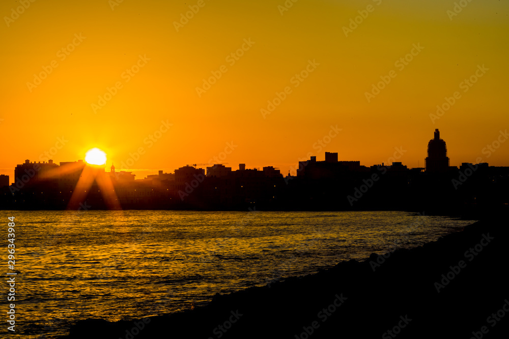 Sunrises over La Malecon, the dramatic sea wall protecting Havana, Cuba