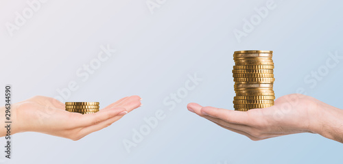 Male hand holding more money then female photo