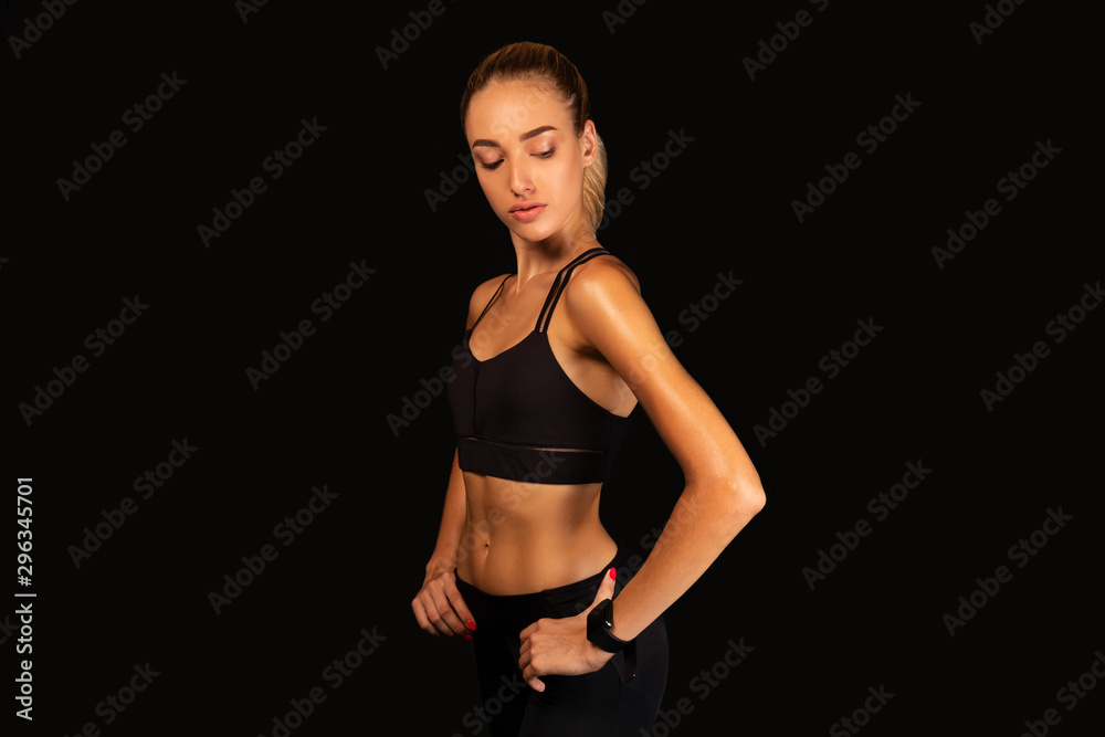 Fototapeta premium Sporty Girl Posing Over Black Background, Studio Shot