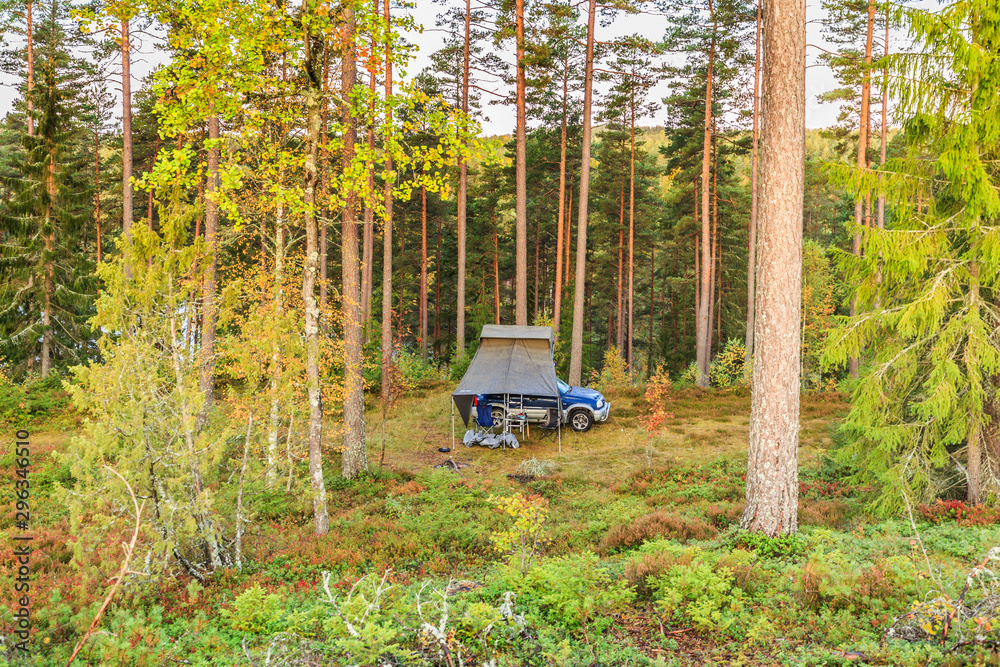 Wild camping in Sweden with 4x4 terrain car and roof tent in a natural  forest at