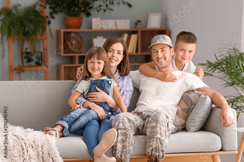 Happy military man with his family at home © Pixel-Shot