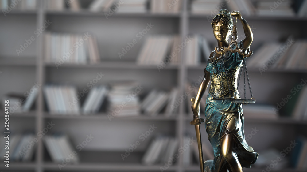 Themis figurine. The criminal law. Low concept. Close up Themis figurine. The criminal law. Low concept. Close up