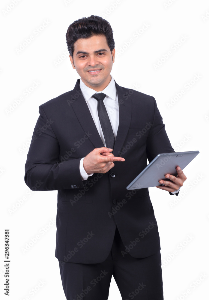 Handsome young businessman pointing at digital tablet on white background Handsome young businessman pointing at digital tablet on white background