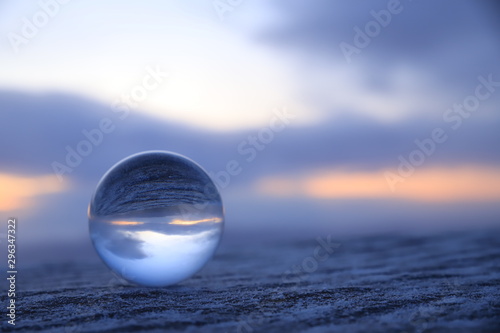 Sunrise through a glass ball photo