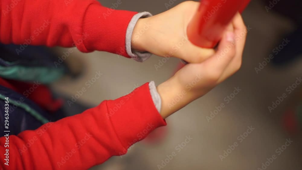 hands in red clothes hold a red tube hands in red clothes hold a red tube