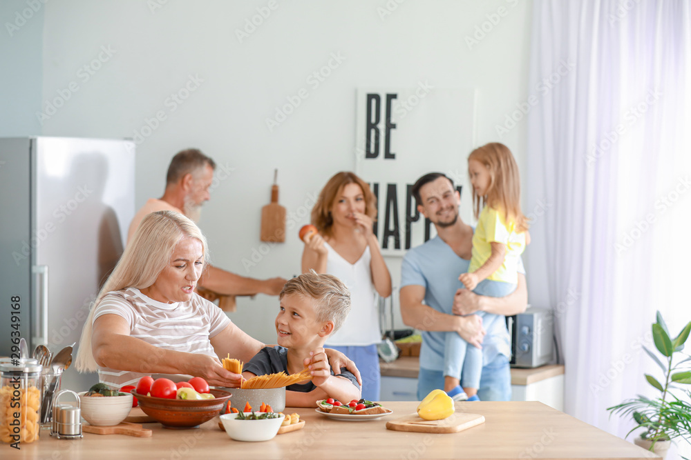 Mature woman with grandson cooking in kitchen Mature woman with grandson cooking in kitchen