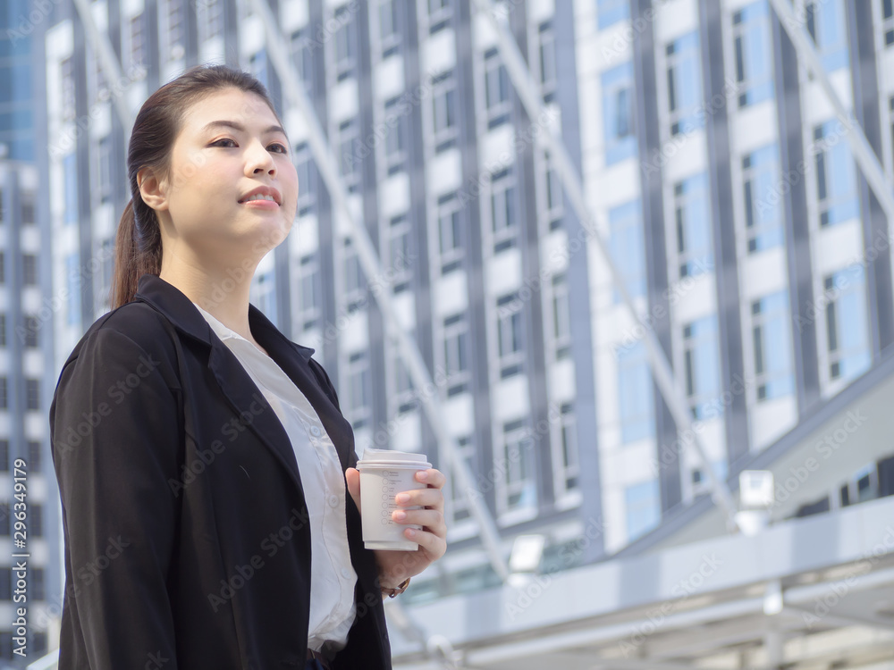 Asian business woman holding coffee paper cup enjoy at outdoor office. Asian business woman holding coffee paper cup enjoy at outdoor office.