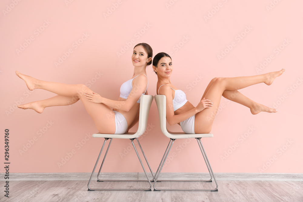Women with beautiful legs after depilation near color wall - obrazy, fototapety, plakaty 