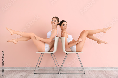 Fotografija Women with beautiful legs after depilation near color wall