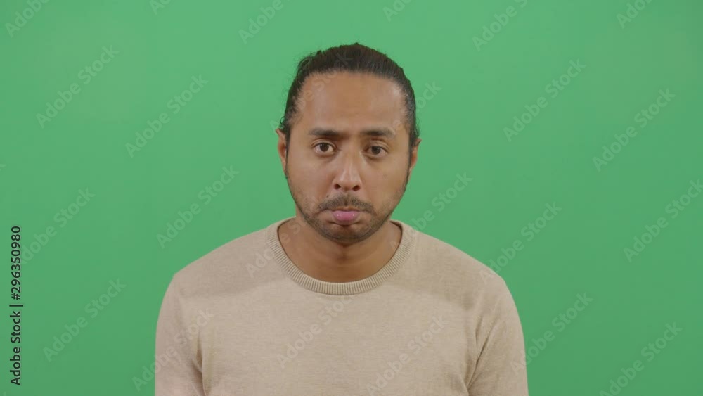 Facial Expression Of A Adult Man Pouting. Studio Isolated Shot Against Green Screen Background Facial Expression Of A Adult Man Pouting. Studio Isolated Shot Against Green Screen Background